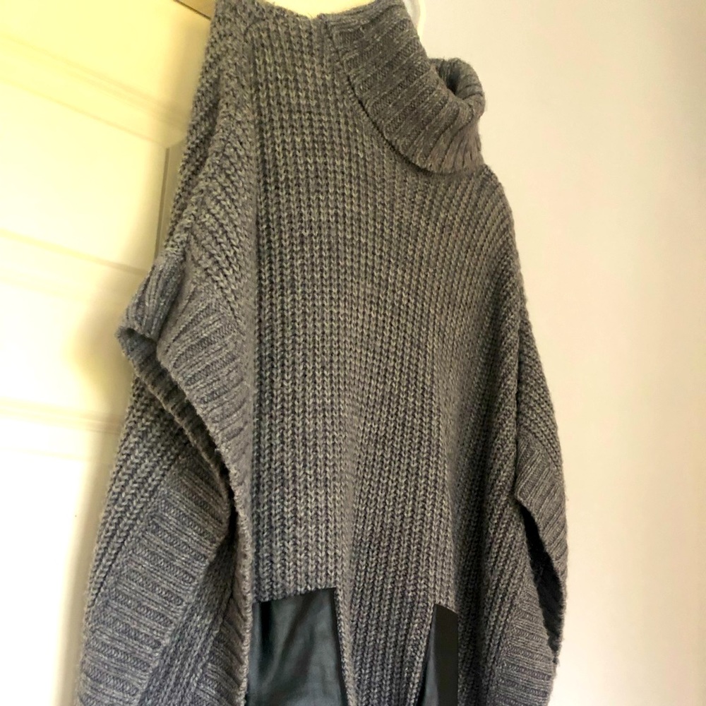 Michael Kors knitted sweater with arm through side openings.